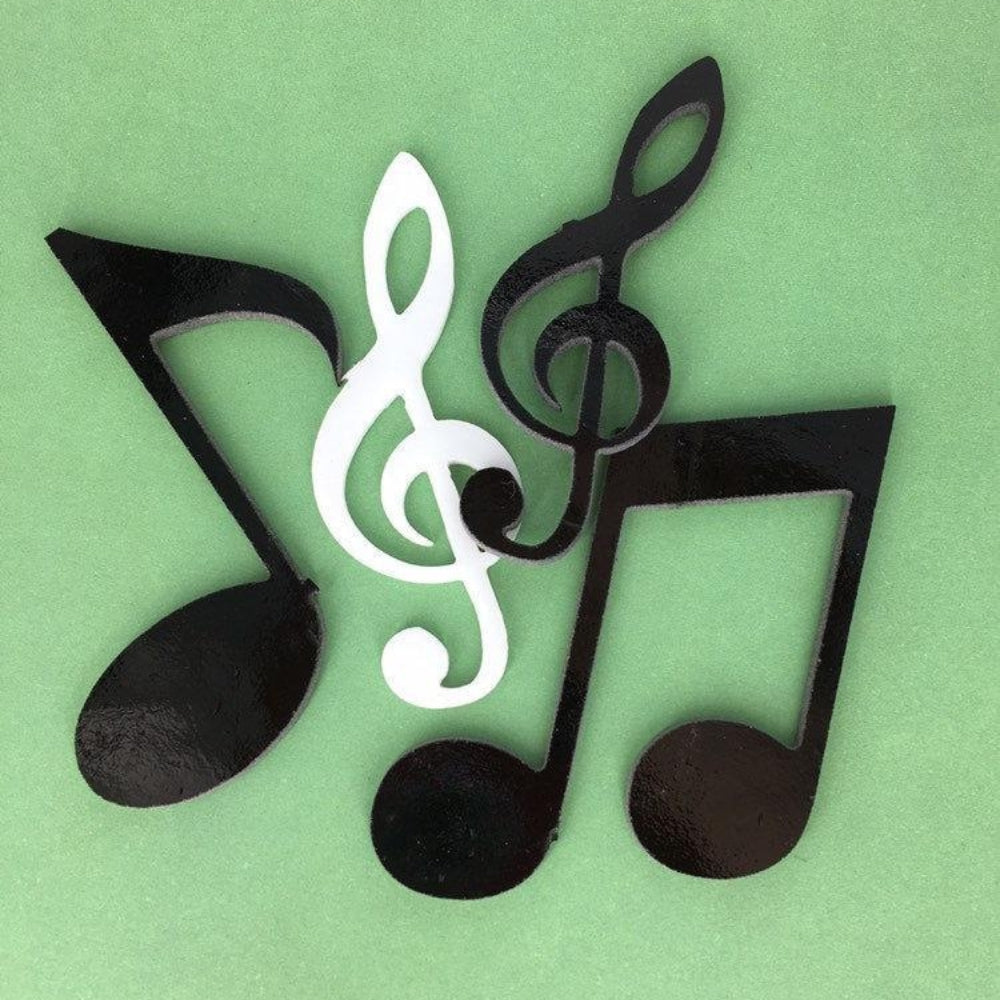 Precut glass shape of musical notes in black and white.
