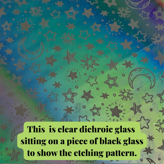 Stars and moon etched dichroic glass on a piece of black glass to show the etched pattern. 
